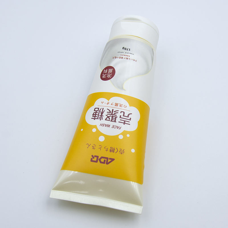 Tube à presser en plastique souple OEM avec couvercle rabattable pour crème pour les mains, lavage du visage, soins de la peau avec surface d'estampage à chaud, lotion cosmétique